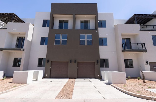 view of property featuring driveway and a garage