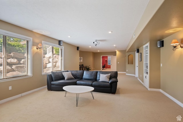 living room with baseboards, recessed lighting, and light colored carpet