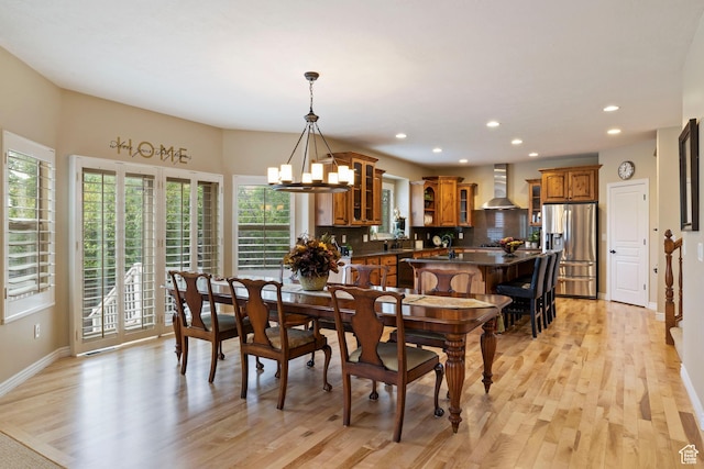 dining area with light wood-style flooring, baseboards, and recessed lighting