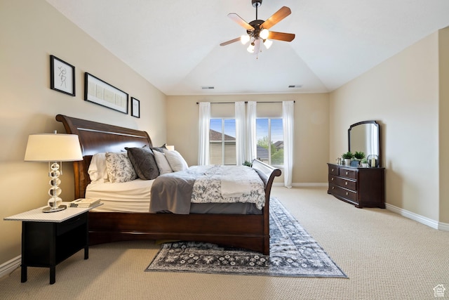 bedroom with light colored carpet, lofted ceiling, baseboards, and ceiling fan