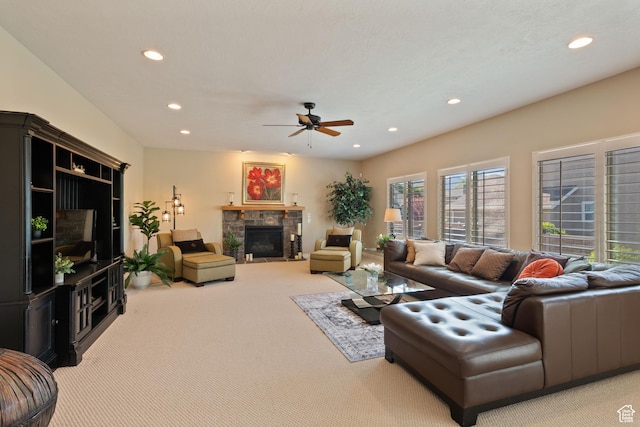 carpeted living room featuring a ceiling fan, a fireplace, and recessed lighting