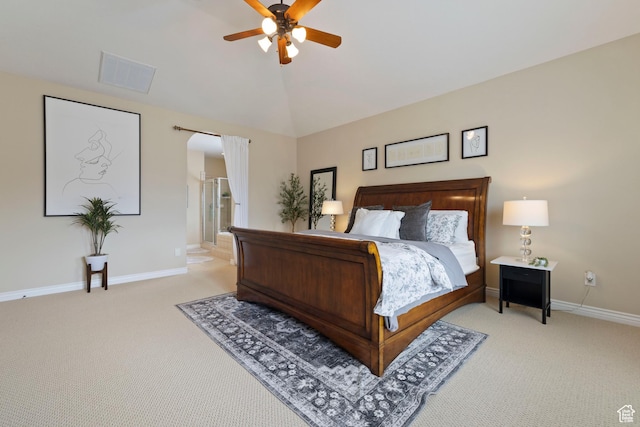 bedroom with baseboards, visible vents, vaulted ceiling, arched walkways, and light colored carpet