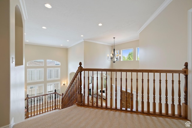 hallway with a notable chandelier, recessed lighting, ornamental molding, an upstairs landing, and carpet floors