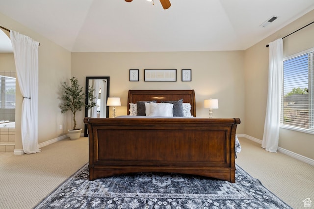 carpeted bedroom featuring vaulted ceiling, baseboards, and visible vents