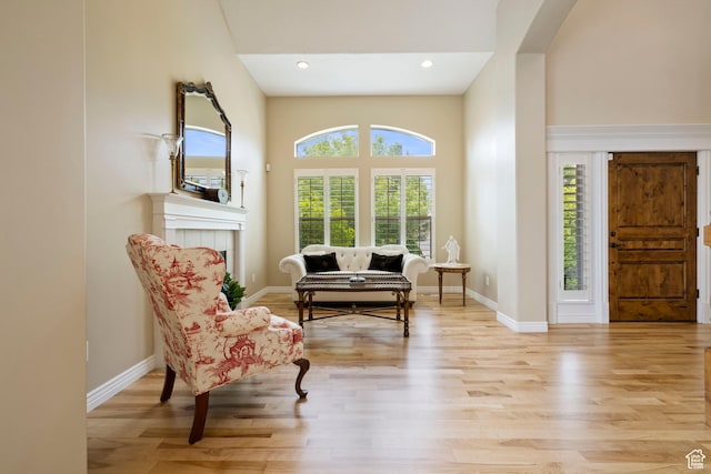 living area with light wood finished floors, baseboards, and recessed lighting