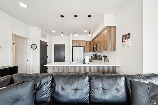 6523 Serviceberry Dr Unit A205, Park City, UT 84098 - kitchen featuring open floor plan, a peninsula, brown cabinets, and stainless steel appliances