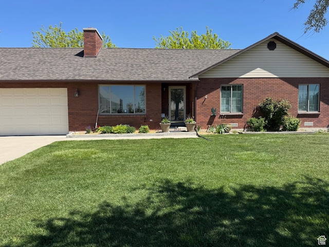 ranch-style house featuring a chimney, a front yard, brick siding, concrete driveway, and an attached garage