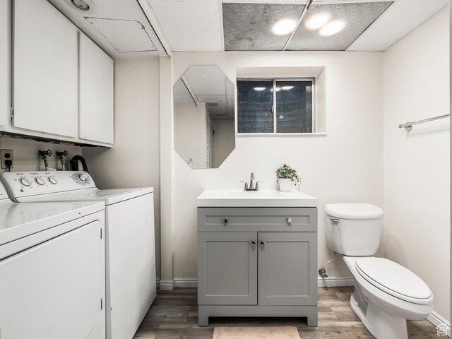 7123 S Watermill Way, Cottonwood Heights, UT 84121 - bathroom with vanity, independent washer and dryer, wood finished floors, and toilet