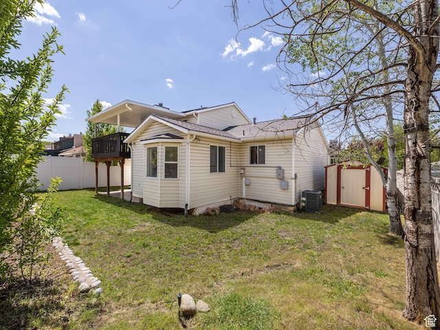 7123 S Watermill Way, Cottonwood Heights, UT 84121 - back of house featuring a lawn, fence, a balcony, an outdoor structure, and a storage unit