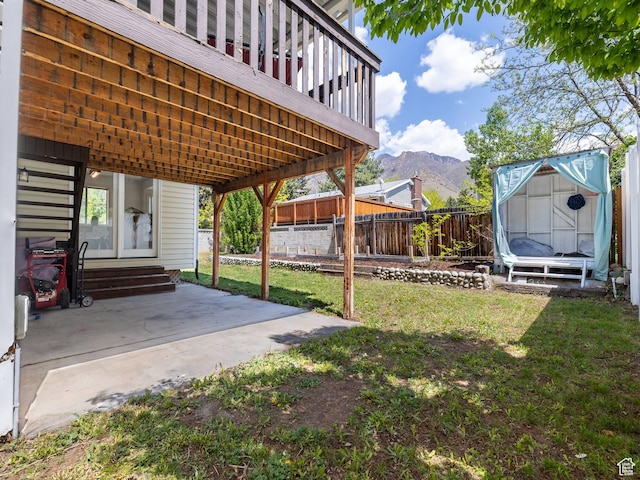 7123 S Watermill Way, Cottonwood Heights, UT 84121 - view of yard featuring a patio area, a fenced backyard, a mountain view, a storage unit, and entry steps