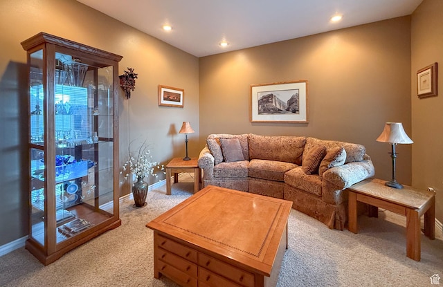 living area featuring baseboards, recessed lighting, and light colored carpet