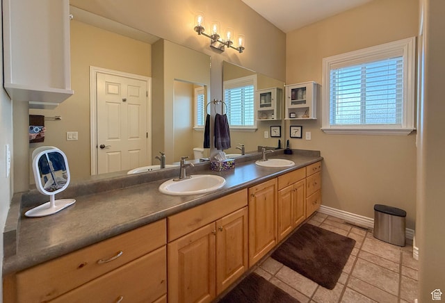full bath featuring a sink, tile patterned floors, and double vanity