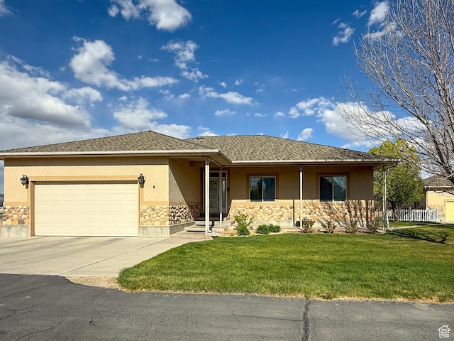 ranch-style home featuring driveway, a garage, a front lawn, stone siding, and stucco siding