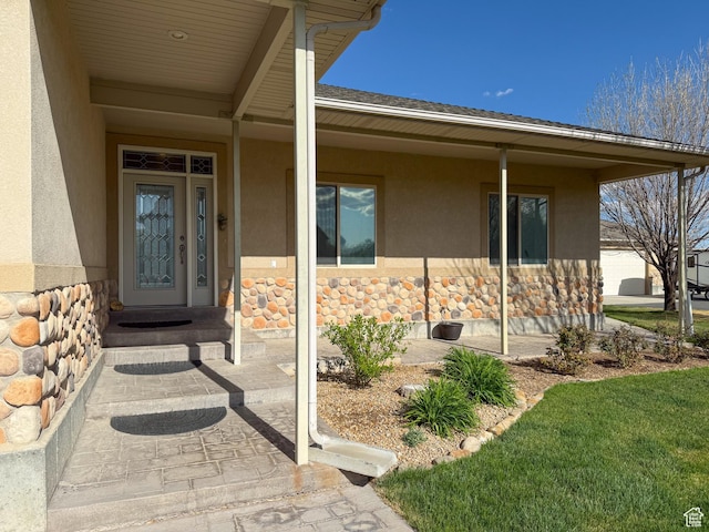 entrance to property with stone siding and stucco siding