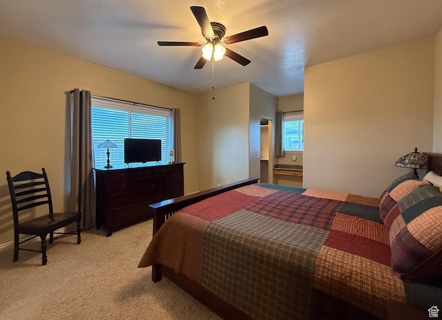 bedroom featuring a ceiling fan and light carpet