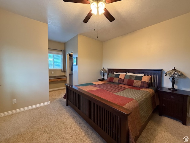 bedroom with light colored carpet, baseboards, and ceiling fan