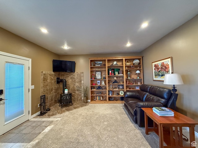 living room featuring recessed lighting, a wood stove, and carpet flooring
