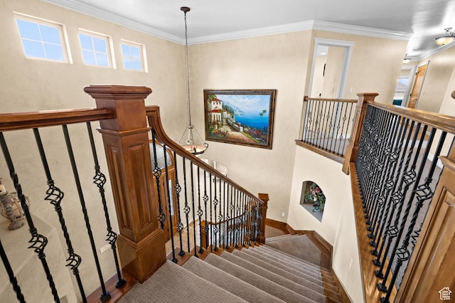 stairway with baseboards and ornamental molding