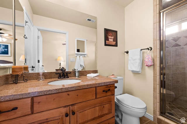 full bath featuring vanity, toilet, a ceiling fan, a shower stall, and visible vents