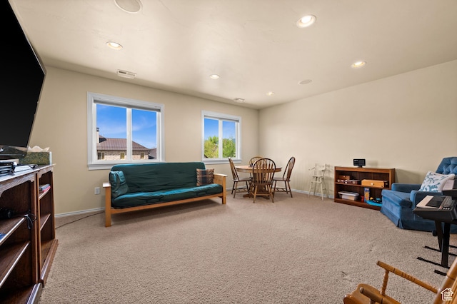 living area with recessed lighting, baseboards, visible vents, and carpet