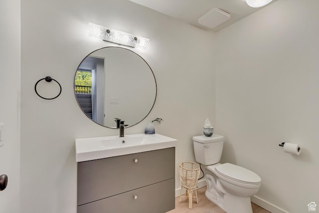 2743 N Edgewood Dr, Provo, UT 84604 - bathroom featuring vanity, baseboards, wood finished floors, and toilet