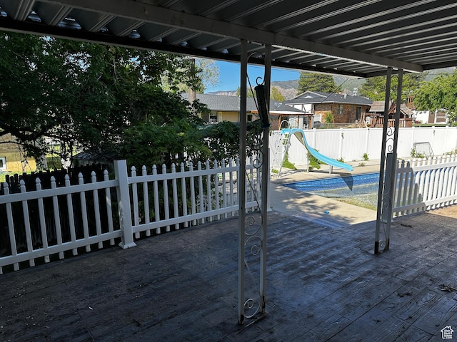5160 S 200 E, Washington Terrace, UT 84405 - wooden terrace featuring a fenced backyard, a patio, and a playground