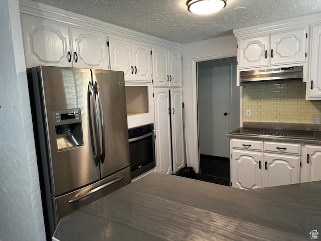 5160 S 200 E, Washington Terrace, UT 84405 - kitchen with stainless steel fridge, under cabinet range hood, oven, dark countertops, and black electric cooktop