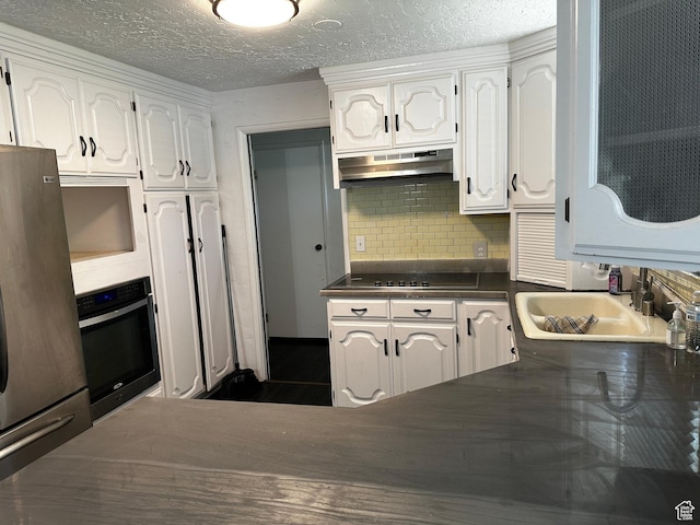 5160 S 200 E, Washington Terrace, UT 84405 - kitchen featuring stainless steel appliances, under cabinet range hood, dark countertops, white cabinets, and a textured ceiling
