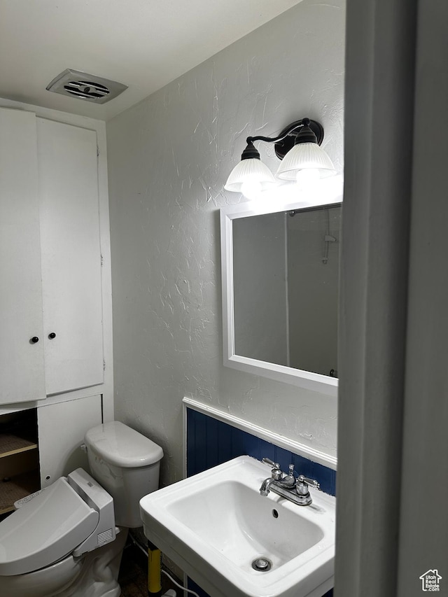 5160 S 200 E, Washington Terrace, UT 84405 - half bathroom featuring a sink, toilet, and a textured wall