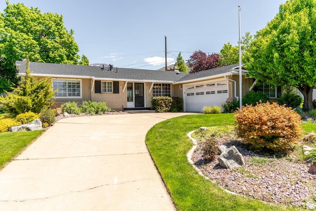 ranch-style home featuring a garage, a front lawn, brick siding, board and batten siding, and concrete driveway