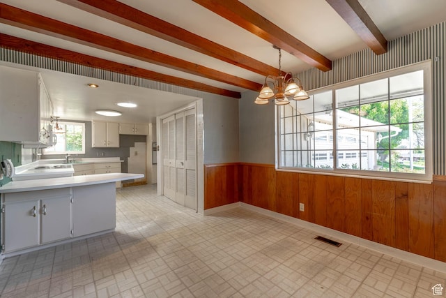 81 S 700 E, Bountiful, UT 84010 - kitchen featuring light countertops, wood walls, a chandelier, brick patterned floor, and a wainscoted wall