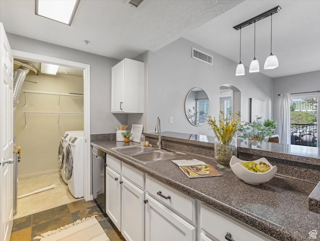165 W Albion Village Way Unit 103, Sandy, UT 84070 - kitchen featuring washer and dryer, white cabinets, a sink, stainless steel dishwasher, and visible vents