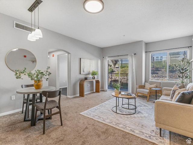 165 W Albion Village Way Unit 103, Sandy, UT 84070 - carpeted living area featuring arched walkways, baseboards, and visible vents