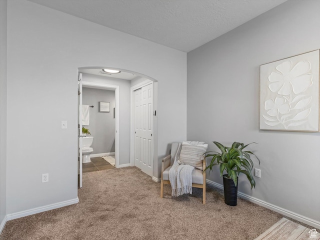 165 W Albion Village Way Unit 103, Sandy, UT 84070 - sitting room with carpet floors, arched walkways, and baseboards
