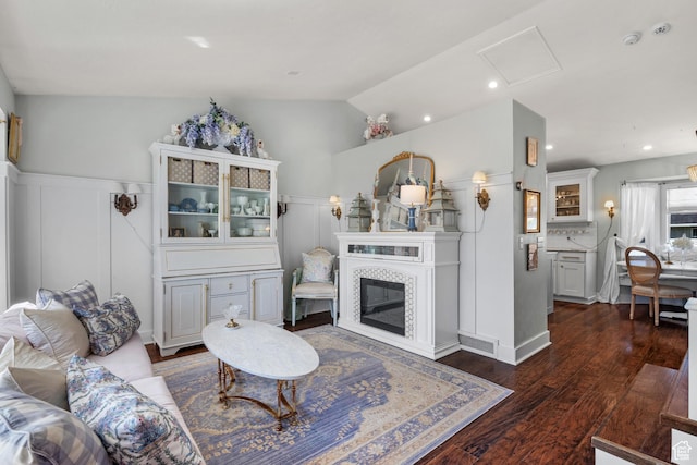 5472 W Aristada Ave S, West Jordan, UT 84081 - living area with dark wood-style flooring, a fireplace, recessed lighting, a wainscoted wall, and vaulted ceiling