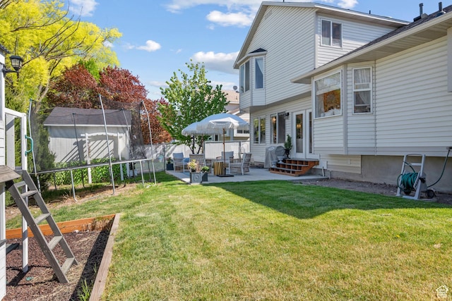 5472 W Aristada Ave S, West Jordan, UT 84081 - view of yard featuring fence, a storage unit, entry steps, a patio area, and an outdoor structure