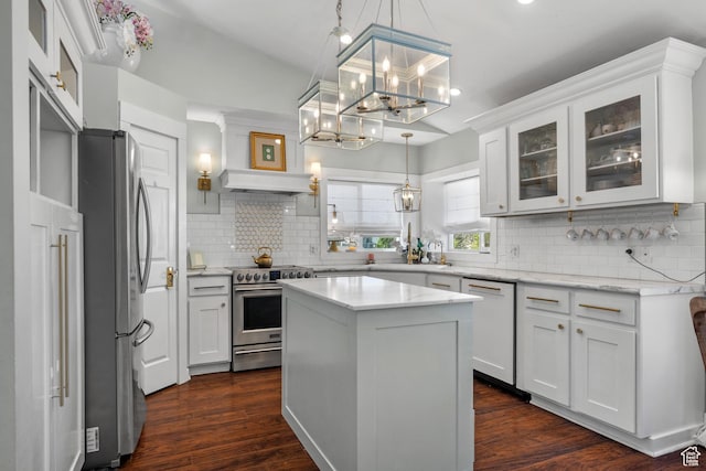 5472 W Aristada Ave S, West Jordan, UT 84081 - kitchen with decorative backsplash, glass insert cabinets, dark wood-type flooring, white cabinets, and stainless steel appliances