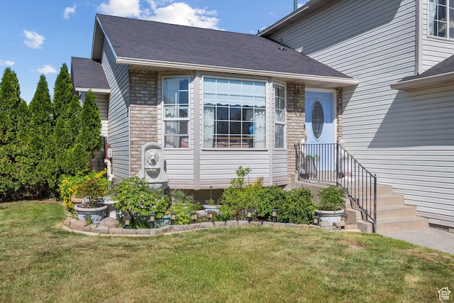 5472 W Aristada Ave S, West Jordan, UT 84081 - view of exterior entry featuring a lawn and a shingled roof