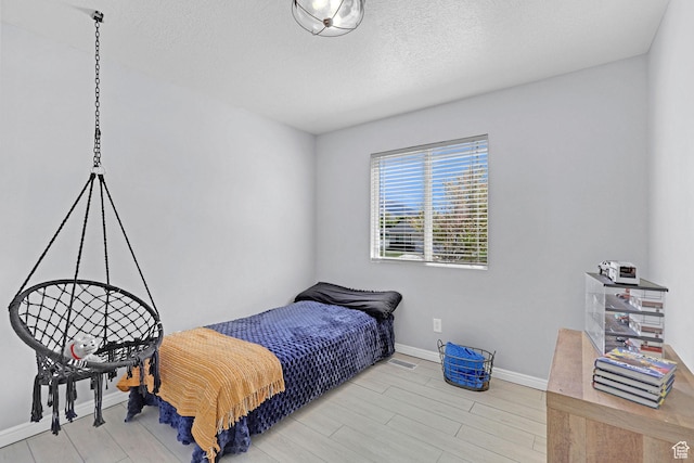 706 E 425 S, Ogden, UT 84404 - bedroom featuring baseboards, a textured ceiling, and wood finished floors