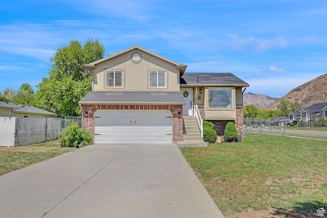 view of front of house with a garage, driveway, brick siding, and a front yard