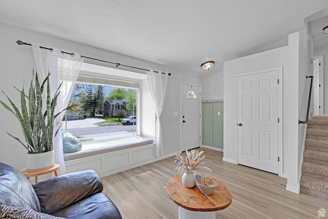 706 E 425 S, Ogden, UT 84404 - living area featuring a textured ceiling, stairway, and light wood-type flooring