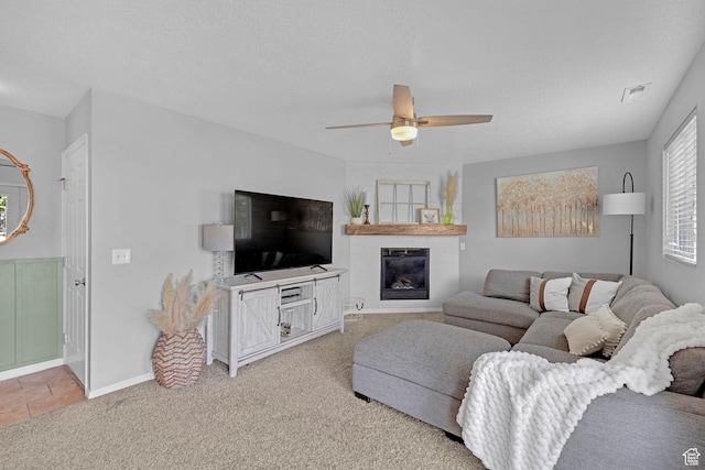 706 E 425 S, Ogden, UT 84404 - living area featuring a ceiling fan, visible vents, a large fireplace, baseboards, and light carpet