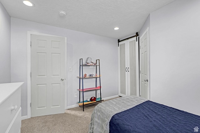 706 E 425 S, Ogden, UT 84404 - carpeted bedroom with recessed lighting, a textured ceiling, a barn door, and baseboards