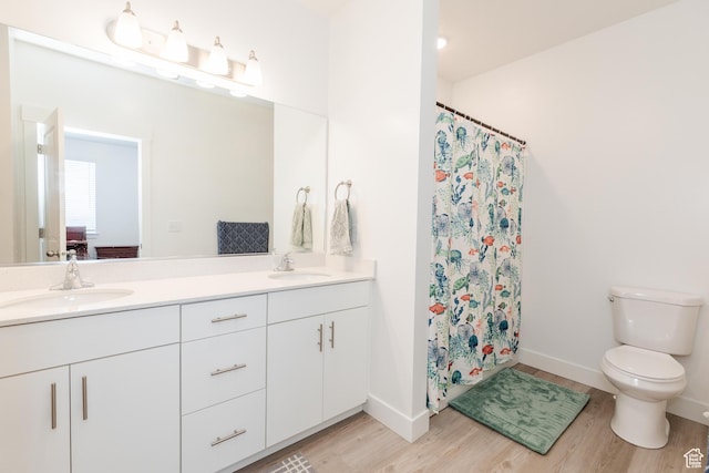 475 W 60 S Unit L303, Providence, UT 84332 - bathroom with a sink, double vanity, toilet, and wood finished floors