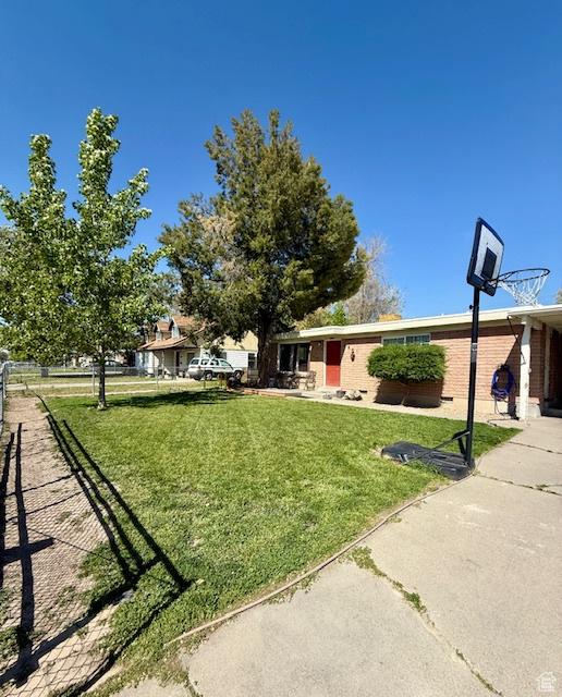 2861 S 3095 W, West Valley City, UT 84119 - view of front of property featuring fence, brick siding, and a front yard