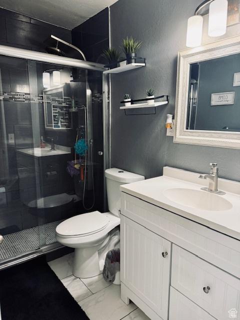 2861 S 3095 W, West Valley City, UT 84119 - full bathroom with a textured wall, vanity, toilet, marble finish floor, and a shower stall