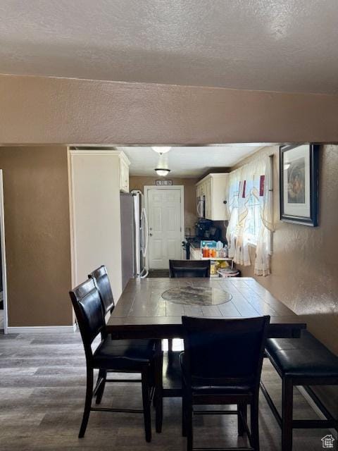 2861 S 3095 W, West Valley City, UT 84119 - dining room with baseboards, a textured ceiling, a textured wall, and wood finished floors