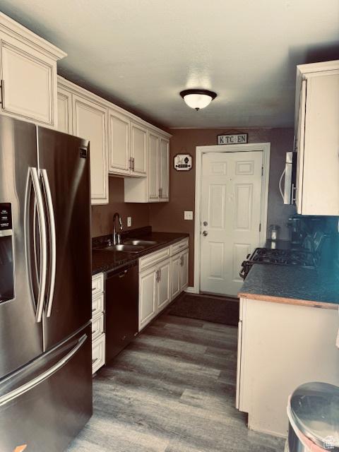 2861 S 3095 W, West Valley City, UT 84119 - kitchen featuring a sink, appliances with stainless steel finishes, dark countertops, and dark wood-style floors