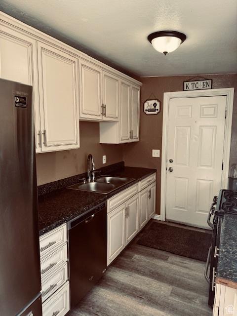 2861 S 3095 W, West Valley City, UT 84119 - kitchen with gas stove, a sink, dishwasher, dark wood finished floors, and freestanding refrigerator