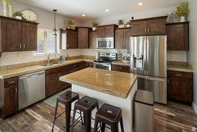 4126 E Cherokee, Eagle Mountain, UT 84005 - kitchen with backsplash, appliances with stainless steel finishes, a sink, and dark wood-type flooring